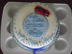 A cake decorated with a model Ferrari